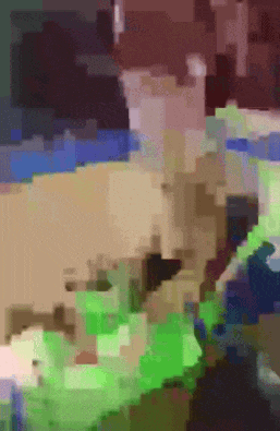 a blurred image of a person with a green shirt on