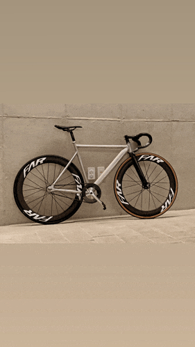 a bicycle is parked in front of a wall that says far