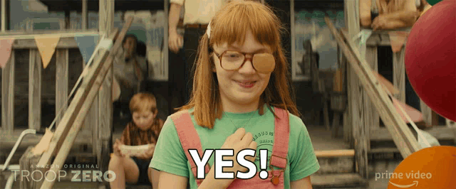a girl wearing glasses and overalls says yes in a prime video ad