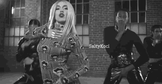 a black and white photo of a woman dancing with the words saltykoci on the bottom right