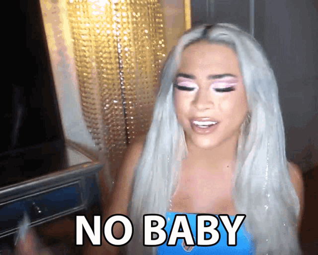 a woman says no baby in front of a chandelier