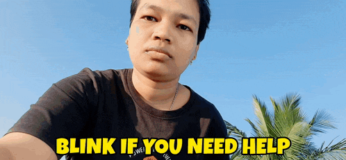 a man in a black shirt with the words blink if you need help on the bottom