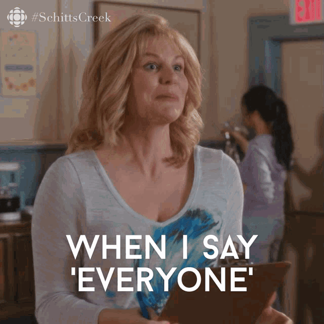 a woman is holding a clipboard and saying when i say everyone