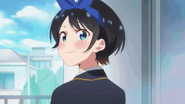 a girl with a blue bow on her head looks at the camera