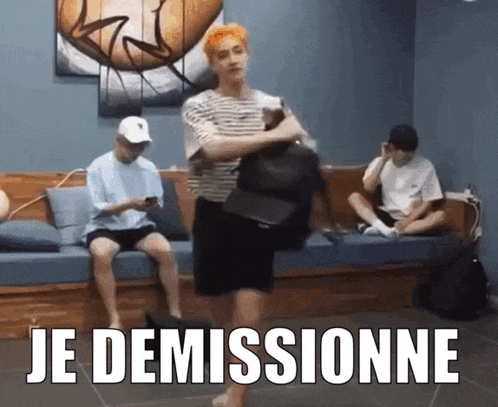 a man in a striped shirt is holding a hat and the word je demissionne is on the floor