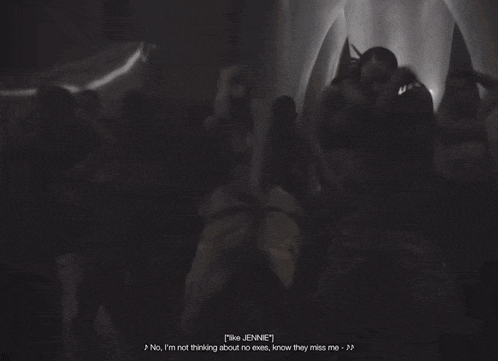 a group of people are dancing in a dark room and one of them says jennie