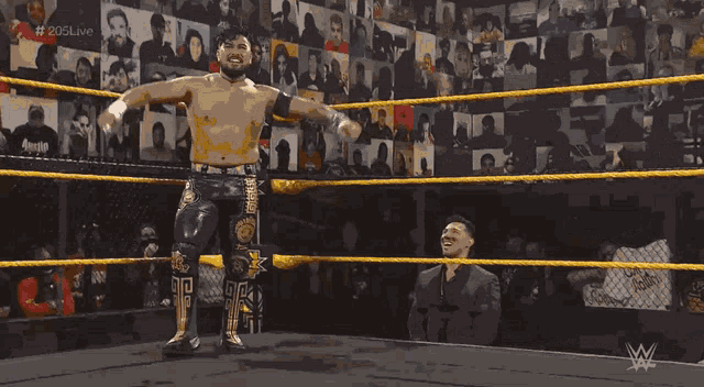 a man in a wrestling ring with the hashtag # 205live on the screen