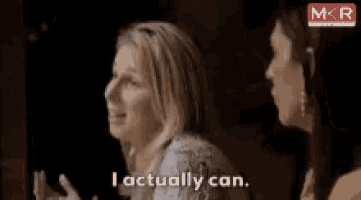 a woman says i actually can while standing next to another woman .