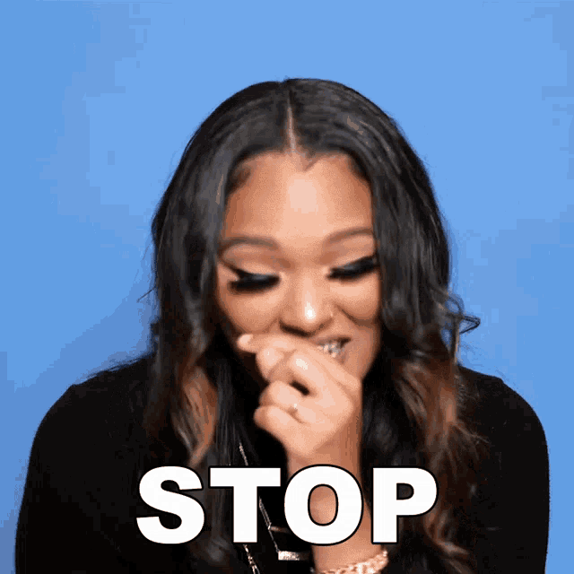 a woman is covering her mouth with her hand and the word stop is written above her