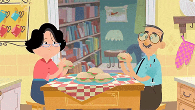 a man and a woman are sitting at a table with sandwiches on it