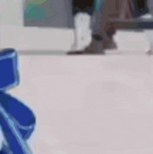 a blurry picture of a person standing in front of a white wall