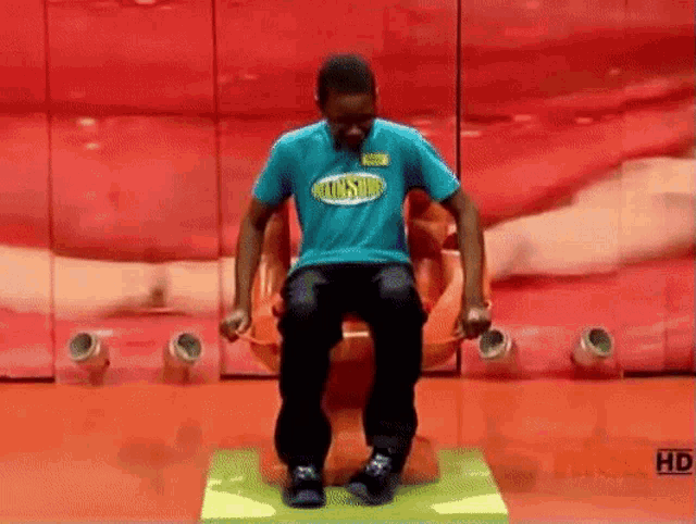 a man in a blue shirt is sitting on a chair