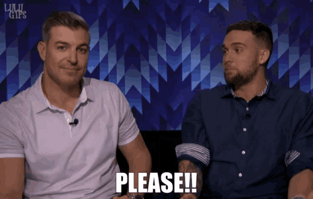 two men are sitting next to each other and one of them has the word please on his chest