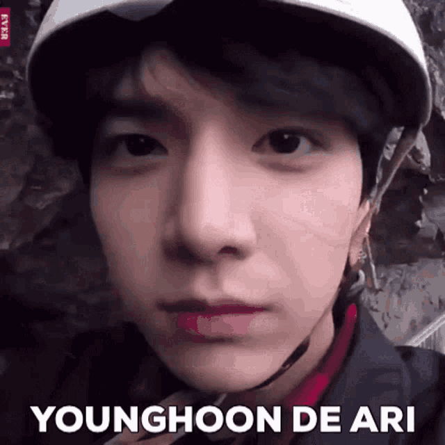 a close up of a young man wearing a helmet with the words younghoon de ari below him
