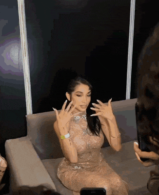 a woman in a dress is sitting on a couch