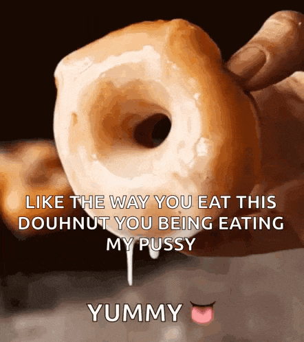 a person is holding a doughnut with a caption that says yummy