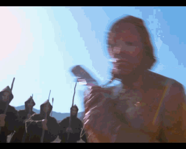 a blurry image of a woman standing in front of a group of men