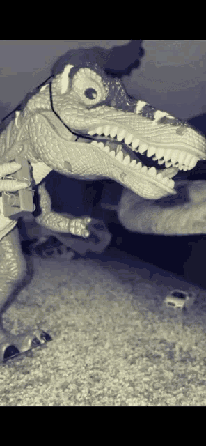 a black and white photo of a dinosaur toy