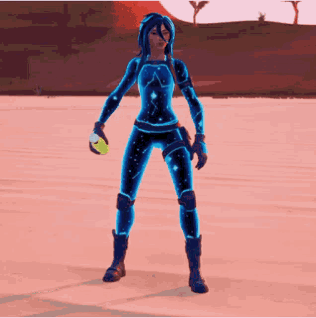 a woman in a blue suit is drinking from a bottle in the desert