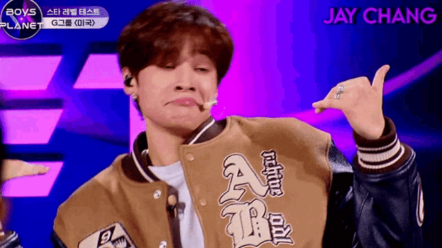 a man wearing a jacket that says native on it makes a funny face