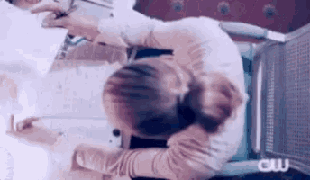 a woman is sitting in a wheelchair looking at a laptop computer .