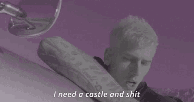 a man laying on a bed with the words i need a castle and shit on the bottom