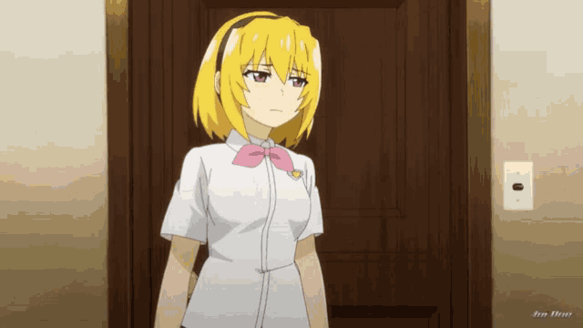 a girl with yellow hair and a pink bow is standing in front of a door