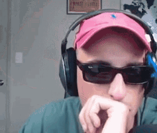 a man wearing headphones sunglasses and a hat