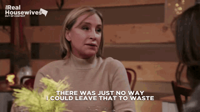 a woman sitting at a table with the words " there was just no way i could leave that to waste " next to her