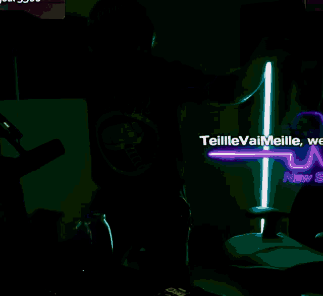 a man is dancing in front of a neon sign that says ' teillevaimeille ' on it