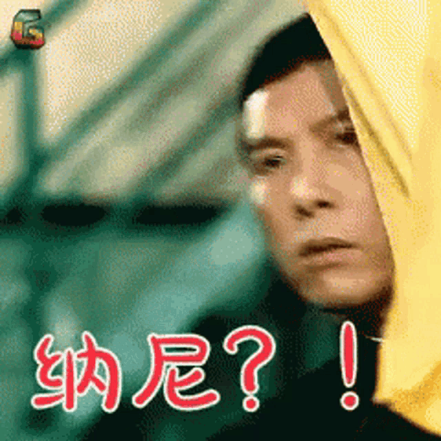 a man wearing a yellow hoodie has a question mark on his forehead