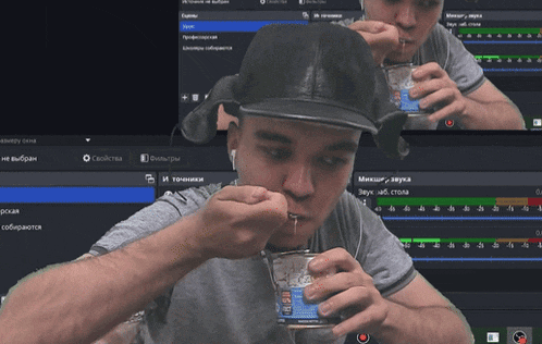 a man in a black hat is eating something from a can