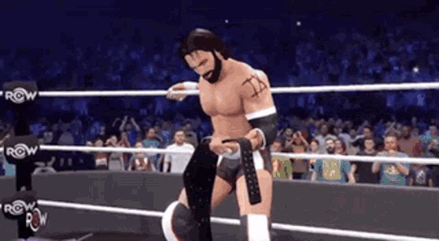 a man in a wrestling ring with the word row on the ring