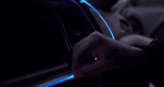 a person is installing a light strip in a car