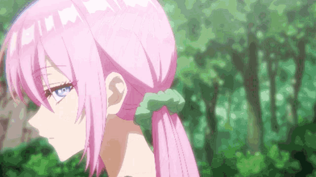 a girl with pink hair and blue eyes is wearing a green scrunchie in her hair .