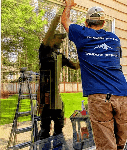 a man wearing a blue shirt that says ' tn glass install window repair '