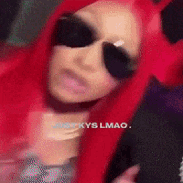 a woman with red hair is wearing sunglasses and says just kys lmao on the bottom