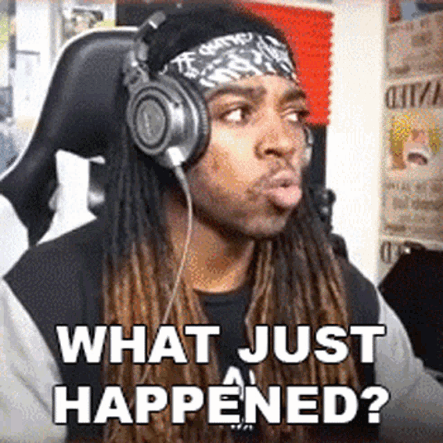 a man with dreadlocks wearing headphones and a bandana says what just happened