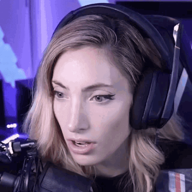 a close up of a woman wearing headphones and a microphone