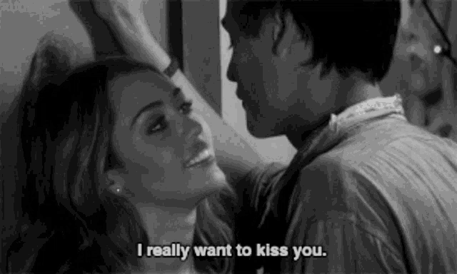 a black and white photo of a man and woman kissing with the caption i really want to kiss you