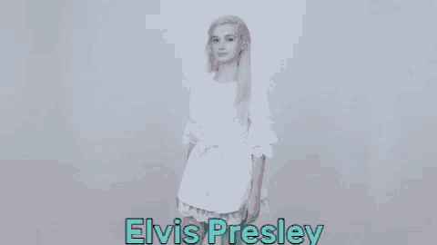 a young woman in a white dress is standing in front of a white background .
