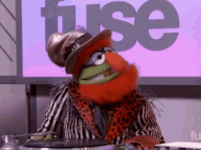 a muppet on a turntable in front of a fuse sign