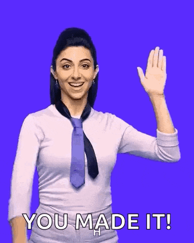 a woman in a tie is waving her hand with the words you made it behind her
