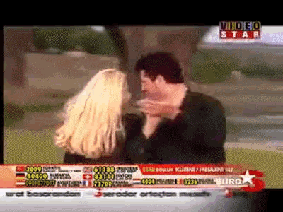 a man and a woman are dancing in front of a video star advertisement