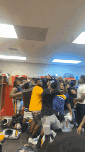 a group of people in a locker room with one wearing a shirt that says chargers on it