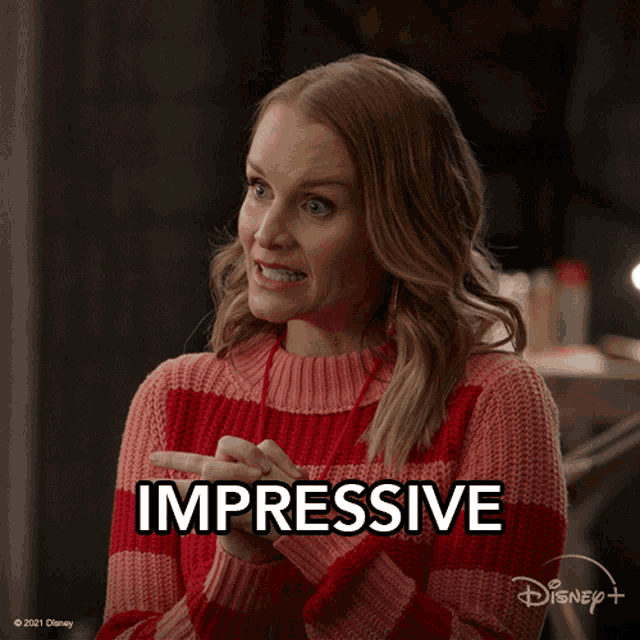 a woman wearing a red and white striped sweater has the word impressive above her