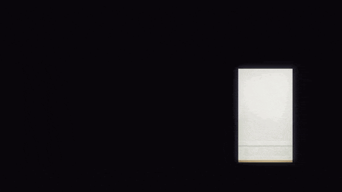 a silhouette of a little girl walking through a doorway .