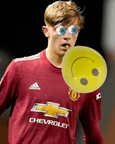a soccer player wearing a chevrolet jersey holds a smiley face