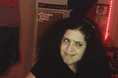 a woman wearing headphones is making a funny face .