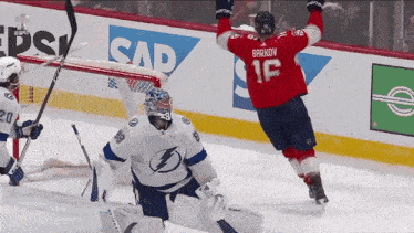 a hockey player in a red jersey with the number 16 on it